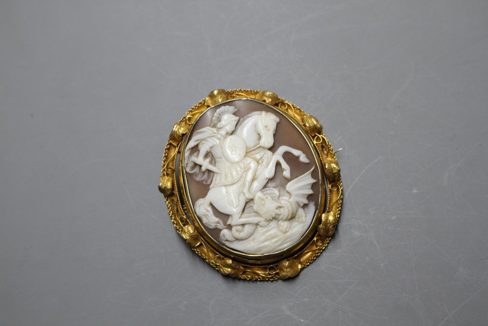 A Victorian yellow metal (tests as 15ct) mounted swivelling oval cameo brooch, carved with St George & the Dragon,